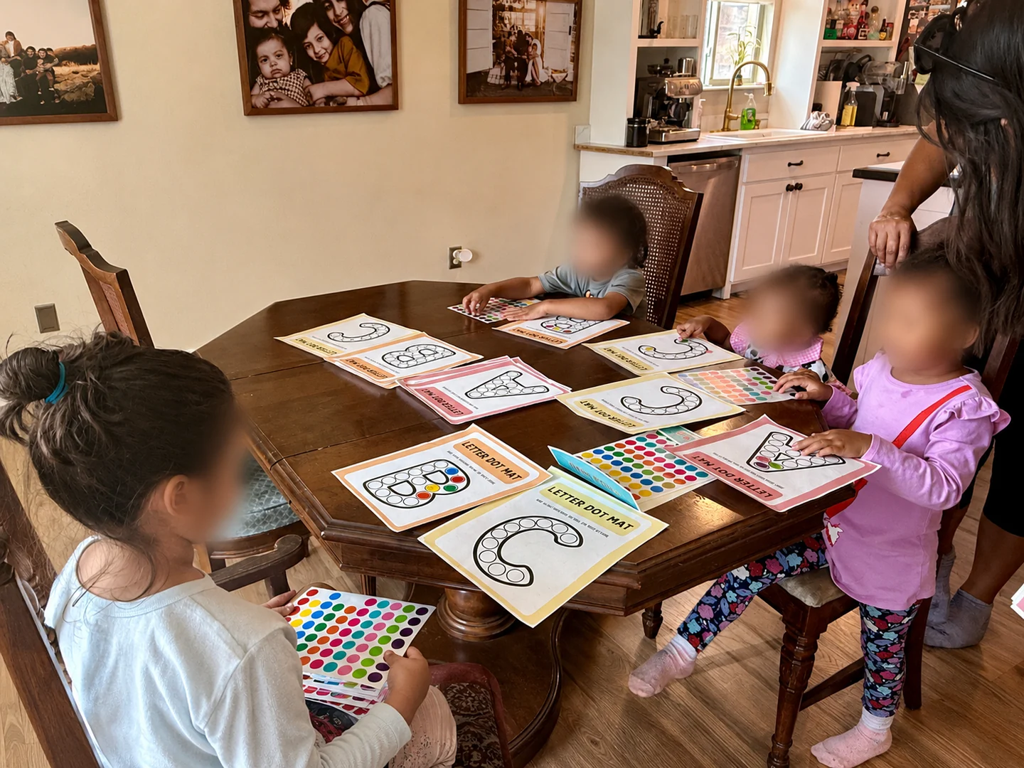 Young learners creating letter projects together around a table